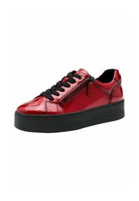 Red patent leather sneaker with black laces, side zipper detail, and a thick black rubber sole. Smooth texture with a glossy finish.