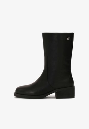 Must musta ankle kottid siledast viimistlusest, ruudu varbaga ja plokknähtavusega kontsaga. Küljel on õrn logodetail.