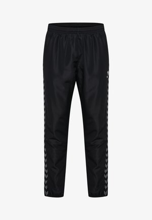 Pantalons de jogging noirs en matériau lisse et léger. Dotés d'une taille élastique et de rayures latérales avec un motif en chevron gris.