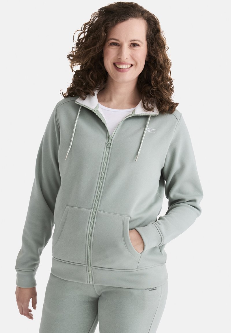 Hellgrüne Zip-Hoodie mit einer weißen Innenauskleidung, ausgestattet mit einer Brusttasche, Kordelzug und gerippten Bündchen. Weicher Stoff, lässiges Design.