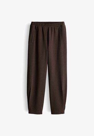 Brown trousers made of textured fabric, featuring an elastic waistband and side pockets, with a relaxed, tapered design.