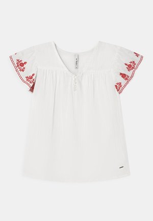 Camicia bianca con maniche corte a volant con ricamo floreale rosso lungo i polsini. Bottoni sul davanti e tessuto dalla trama lavorata.