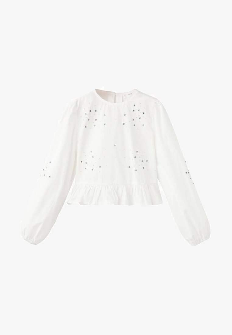 Biały top z długim rękawem, okrągłym dekoltem, falbanką u dołu oraz ozdobami w srebrnym kolorze rozmieszczonymi na przodzie i rękawach.