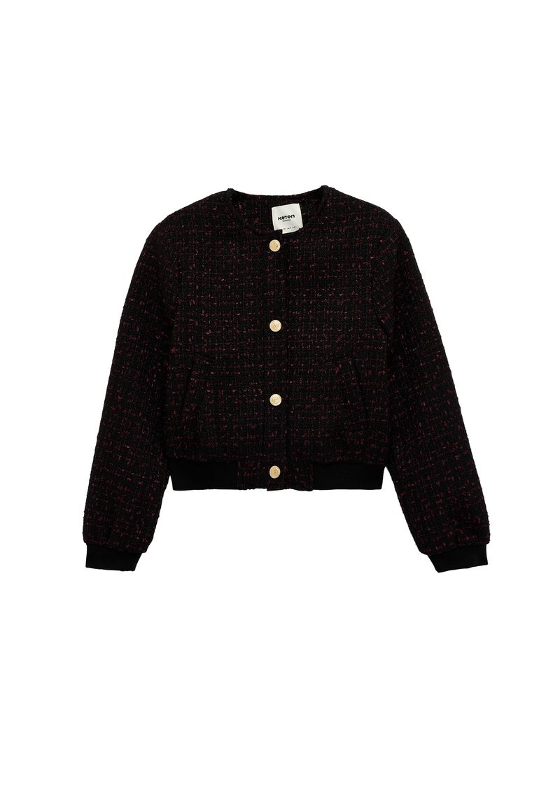 Czarna i czerwona kurtka z tweedu o skróconym kroju, z złotymi guzikami, długimi bufkami i czarnymi dzianinowymi mankietami na dole.