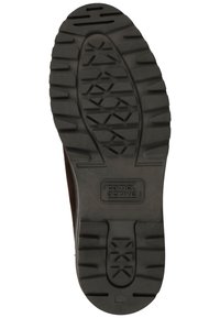 Schwarze Gummisohle mit einem strukturierten Grip-Muster und einem zentralen Emblem mit der Aufschrift "camel active". Obermaterial aus braunem Leder, das am Rand sichtbar ist.