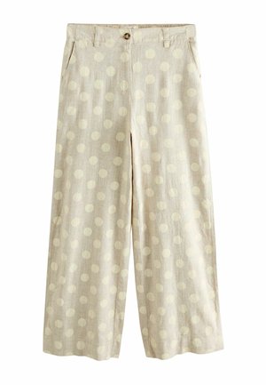 Beige vidde bukser med høj talje, knaplukning, sidelommer og et stort prikkemønster over hele stoffet.