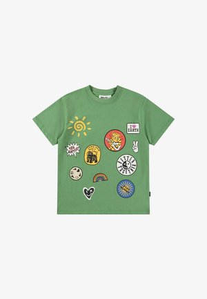 Green t-shirt with colorful patches including sun, rainbow, bear, peace hand, and phrases like "I love Earth," "You Matter," and "Better Together."