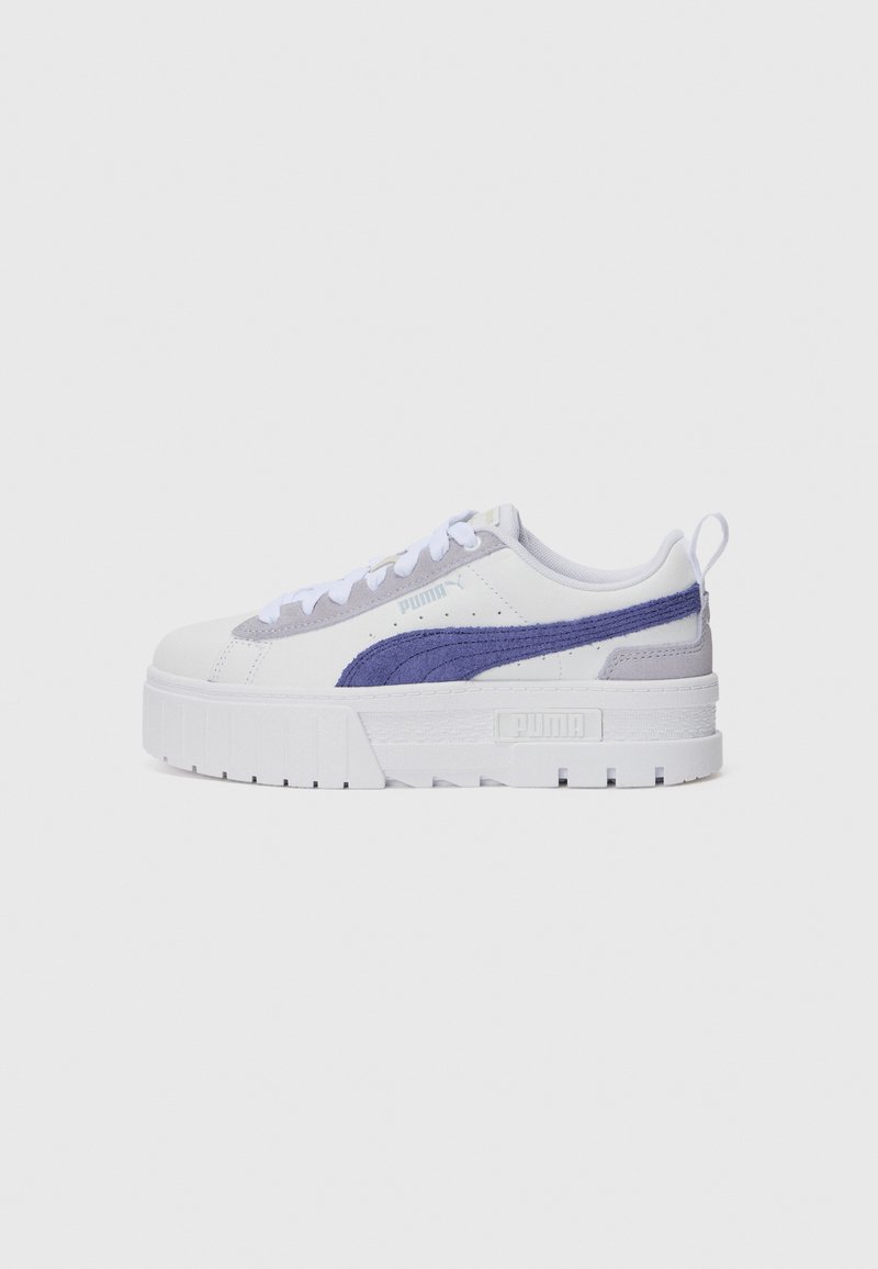White sneakers with purple accents, suede and textile materials, platform sole, lace-up design, featuring a logo on the side.