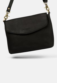 Black leather crossbody bag with flap closure and detachable strap featuring gold-tone clasps and hardware details.