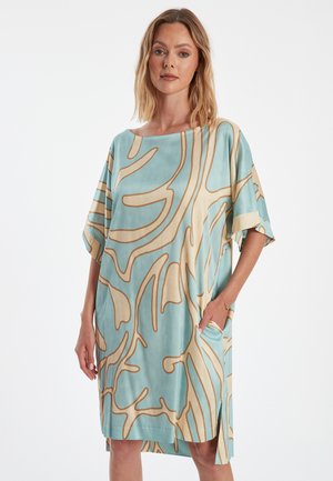 Loszittende jurk met korte mouwen in lichtblauw met beige abstracte patronen. Heeft een brede halslijn en zijzakken. Gladde stoftextuur.