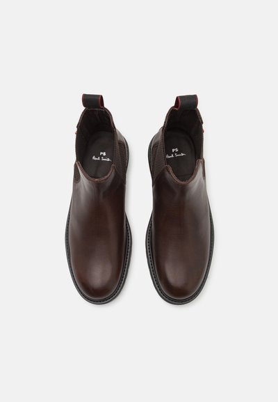 Pair of polished dark brown leather slip-on ankle boots with black elastic side panels and pull tabs, viewed from above.
