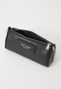 Black leather clutch bag with a rectangular shape, silver hardware, a zip closure, and a logo patch on the front. Interior has card slots.