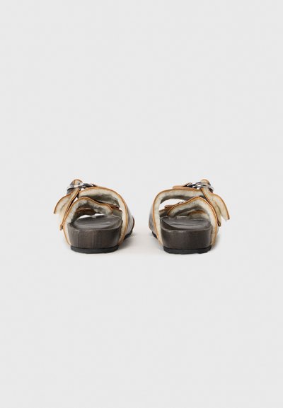 Brown leather sandals with adjustable straps, a cushioned insole, and a sturdy black outsole. Open back design with soft lining.