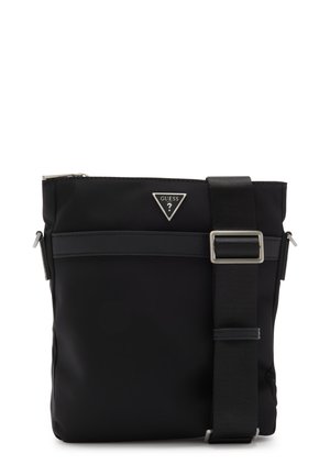 Sac crossbody noir en nylon avec bandoulière réglable, poche zippée avant et logo de marque triangulaire. Texture lisse et design minimaliste.