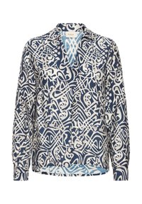 Blouse à manches longues bleu marine avec un motif abstrait blanc, un col et un devant sans boutons, avec un ourlet légèrement courbé et un tissu texturé.