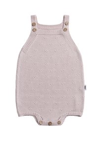 Gebreide baby romper in zachtroze, met gestructureerde stippen, verstelbare knoopbanden en een drukknoopsluiting aan de onderkant.
