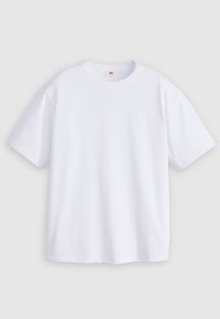 T-shirt en coton blanc à manches courtes, col rond et coupe décontractée. Le matériau semble lisse sans motifs ni graphiques visibles.