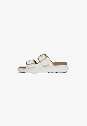 White slide sandal with two adjustable buckled straps and a thick sole with light brown footbed, side view on white background.