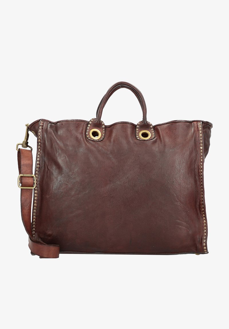 Bruine leren totebag met twee handvatten bovenaan en een afneembare schouderband, voorzien van gouden ringen en studaccenten langs de zijkanten.