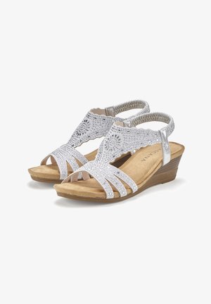 Silver wedge sandals with a textured, beaded upper and open toe design. Features a cushioned insole and elastic strap for comfort.