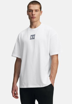 White cotton t-shirt featuring a square gray logo on the chest. Relaxed fit with short sleeves and a round neckline.