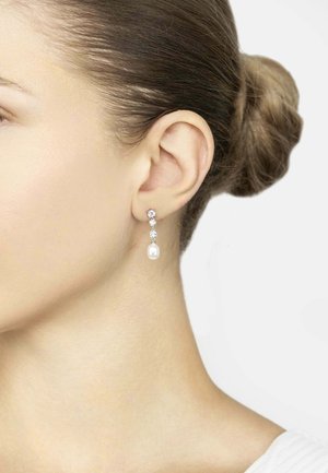 Pearl drop earrings featuring a metallic structure, clear crystal accents, and a smooth, round pearl at the base. Color: silver and white.