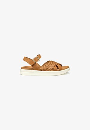 Brown suede sandal with woven accents and an adjustable ankle strap. White midsole provides cushioning. Open-toe design.