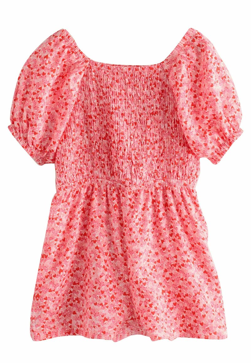 Kurzes rosa Kleid mit gerafftem Oberteil und ausgestellt Rock. Es hat ein verstreutes Herzmuster in helleren und dunkleren Rosatönen.