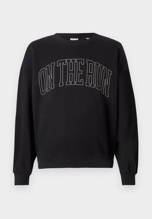 Svart crewneck genser med teksten "ON THE RUN" i store, konturerte bokstaver sentrert foran.