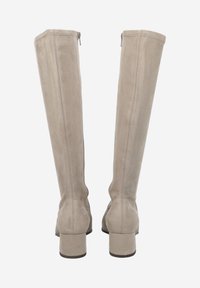 Beige suede over-the-knee boots with a block heel, featuring a zipper at the back and visible stitching details. Smooth texture.