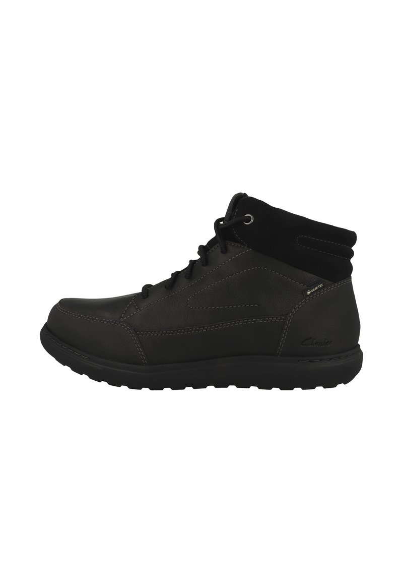 Bottes mi-hautes noires en cuir et suède, dotées d'un laçage, d'un col rembourré et d'une semelle en caoutchouc texturé.