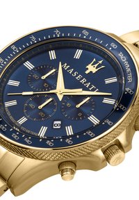 Orologio dorato con quadrante blu navy, indici bianchi, cronografi e sottodial. Resistente all'acqua fino a 100 metri.