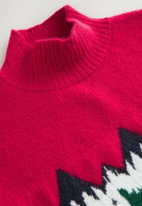 Knitted sweater with a high, ribbed pink collar. Features a textured pink body and a geometric white, black, and green pattern at the hem.