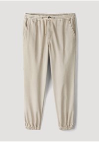 Beige casual jogger pants with elastic waistband and drawstring, side pockets, and elastic cuffs at ankles.