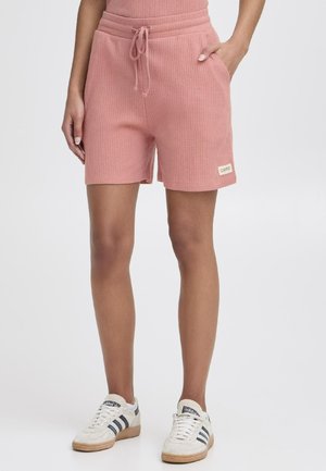 Roze geribde shorts met een elastische tailleband en koord, voorzien van zijzakken en een klein merklabel op de zoom.