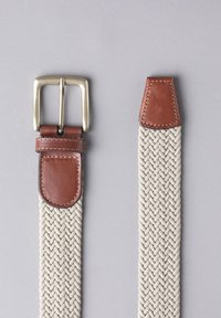 Woven beige belt with a braided texture, featuring a silver metal buckle and brown leather accents at the tip and buckle attachment.