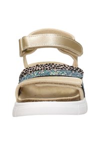 Gold and animal print sandals featuring a chunky white sole, adjustable straps, and a blue glitter accent across the middle.