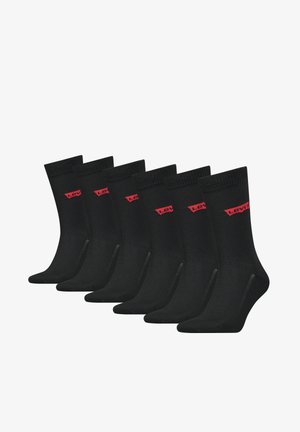 Black cotton socks with ribbed cuffs, featuring red "Levi's" logo. Six pairs displayed in a row, showing a smooth texture and classic design.