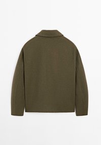 Grøn uld-blandingsjakke med slået krave, strukturerede skuldre og en glat tekstur. Renset, enkelt design uden lukninger.