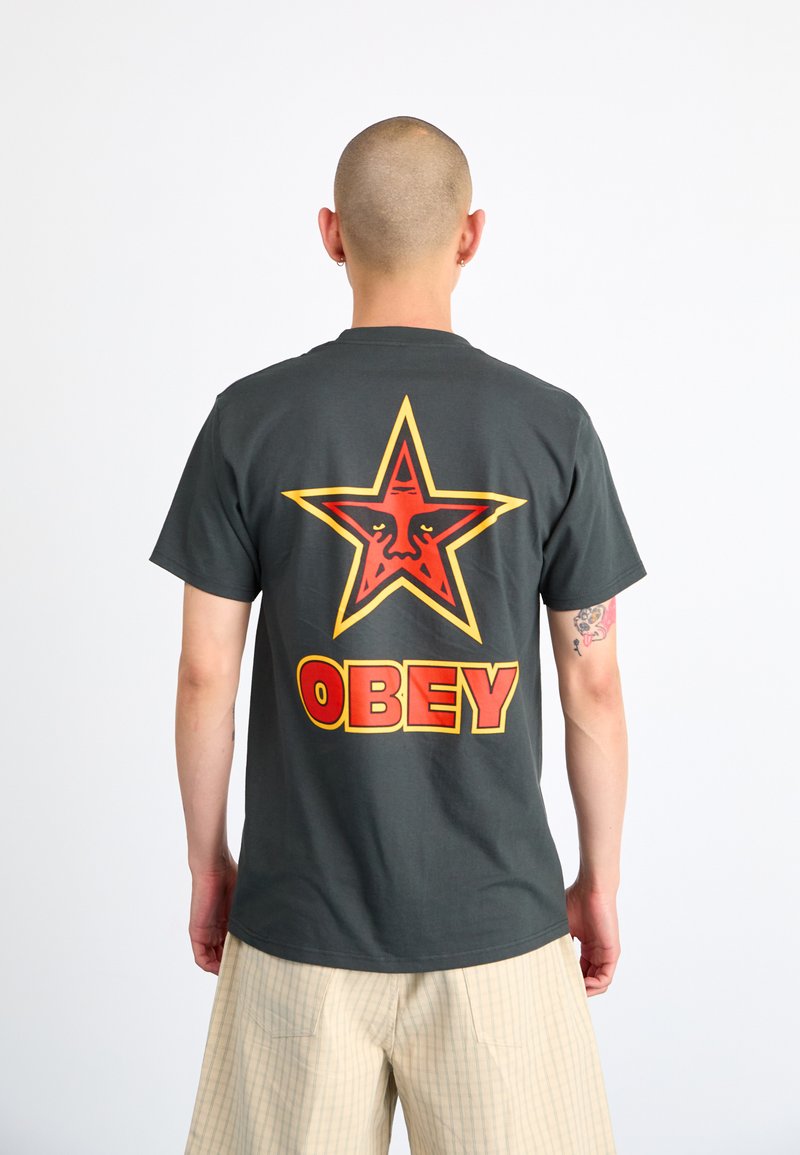 Gray cotton t-shirt with a large red and yellow star graphic and "OBEY" text on the back. Short sleeves and a standard fit.