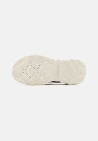 Rubber sneaker outsole in white, featuring a textured pattern for grip and drainage. Logo detail "GEOX" embossed on the midsole.