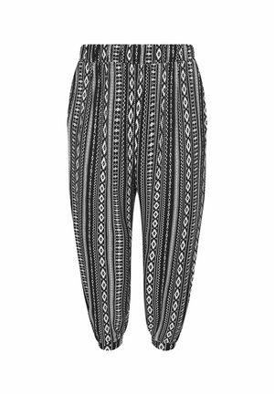 Schwarz-weiße gemusterte Hose mit elastischem Bund, die vertikale Streifen und geometrische Designs aufweist. Mit umgeschlagenen Säumen an den Knöcheln.