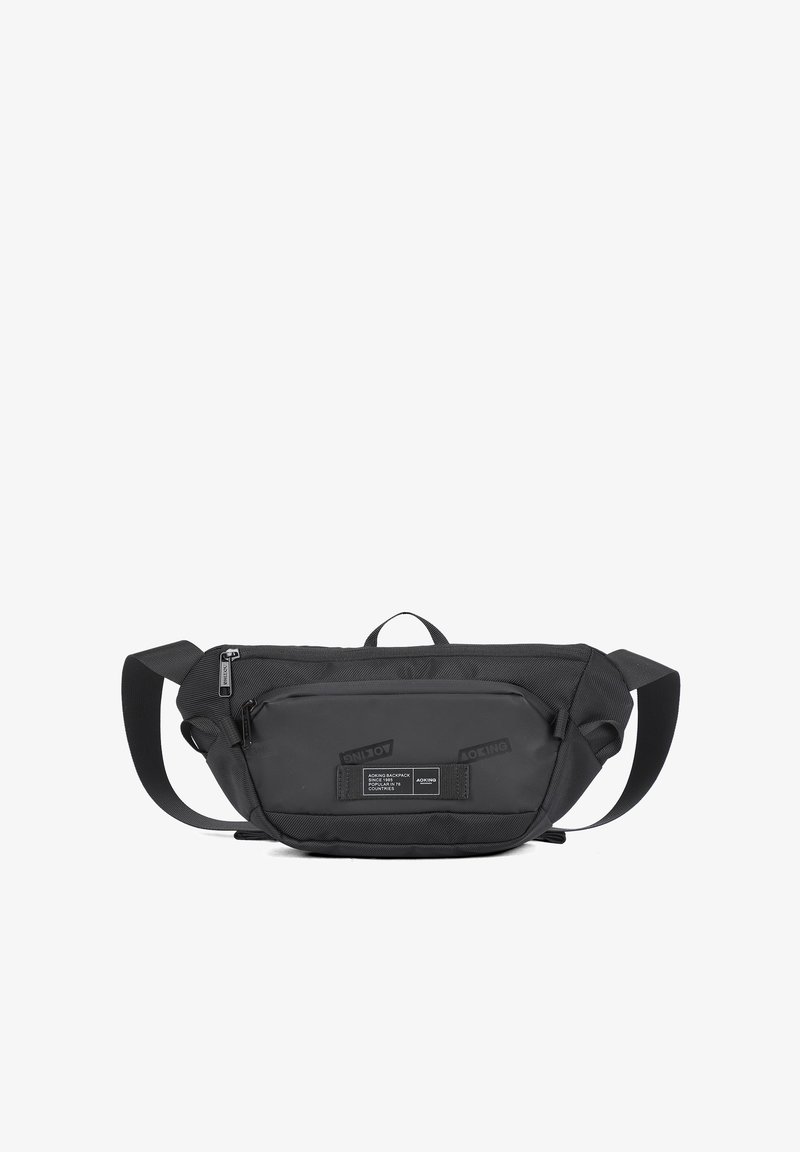 Borsa a tracolla nera con un design elegante, caratterizzata da una superficie testurizzata, scomparti con zip e una patch con il marchio sulla parte anteriore.