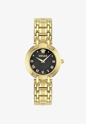 Orologio oro con quadrante rotondo nero, numeri romani e centro testurizzato. Il bracciale presenta un motivo a chiave greca.