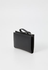 Black leather wallet with a smooth texture and a zip closure. Features a wrist strap and a minimalistic design with no visible patterns.