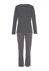 Gray long-sleeve top with scalloped hem paired with patterned pajama pants featuring pink and white cross designs on a dark background.