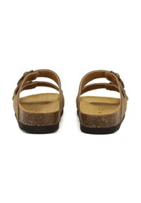 Sandali in pelle marrone con soletta in sughero. Due cinturini regolabili e parte posteriore arrotondata. Suola testurizzata per una migliore aderenza. Design minimale.