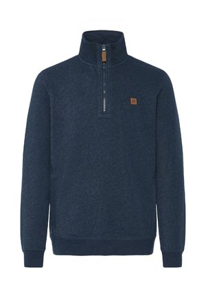 Sudadera de color azul marino con cuello alto, media cremallera y un parche de cuero marrón. Fabricada en tejido texturizado, con puños y dobladillo acanalados.