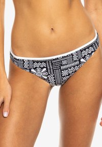 Black and white bikini bottom with geometric patterns, featuring a low-rise cut and a white waistband. Smooth fabric texture.