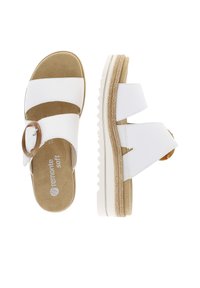 White sandals with brown buckle, textured sole, and platform design. Features adjustable straps and soft suede insole for comfort.